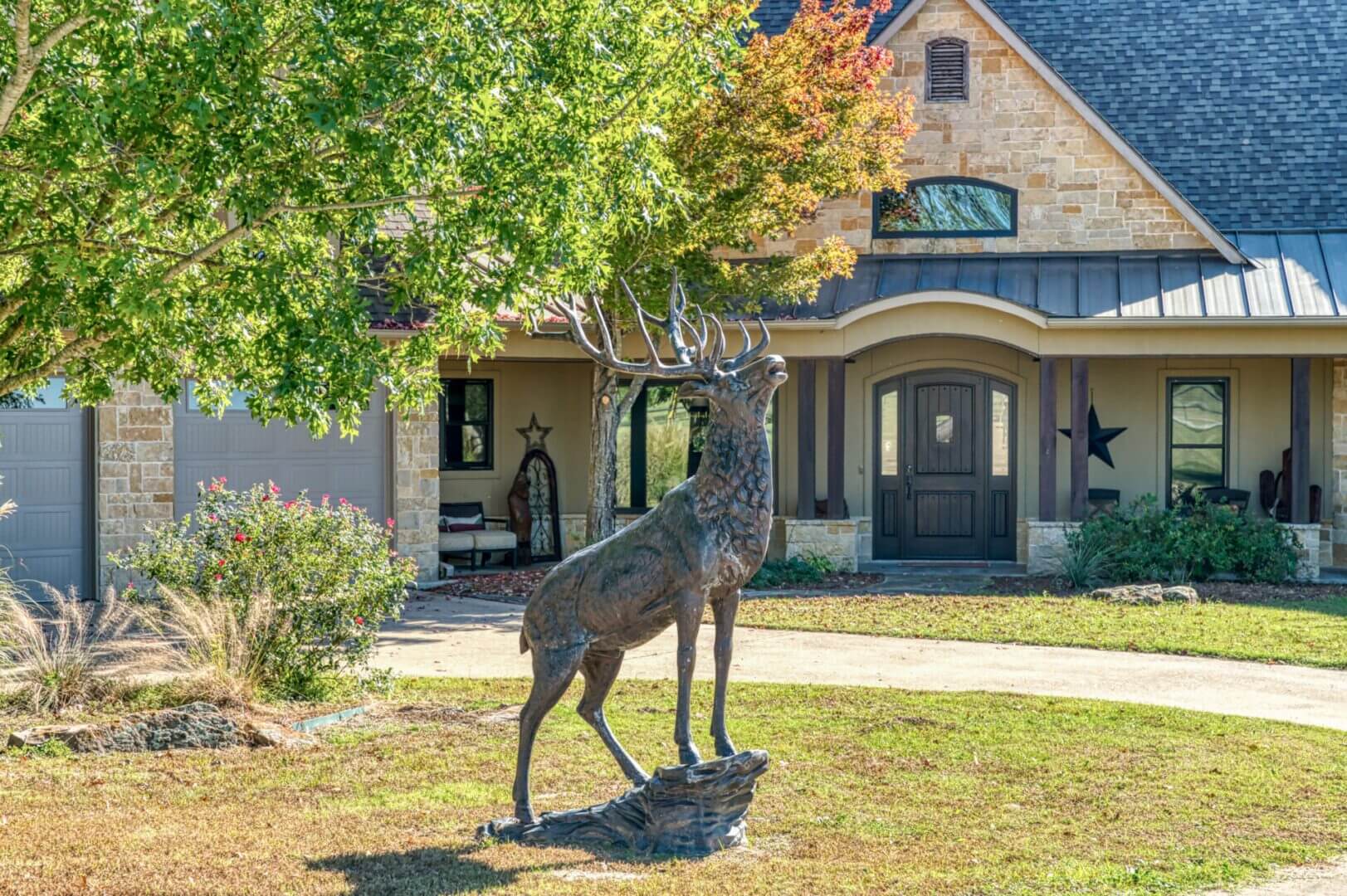 Stone house with yard sculpture