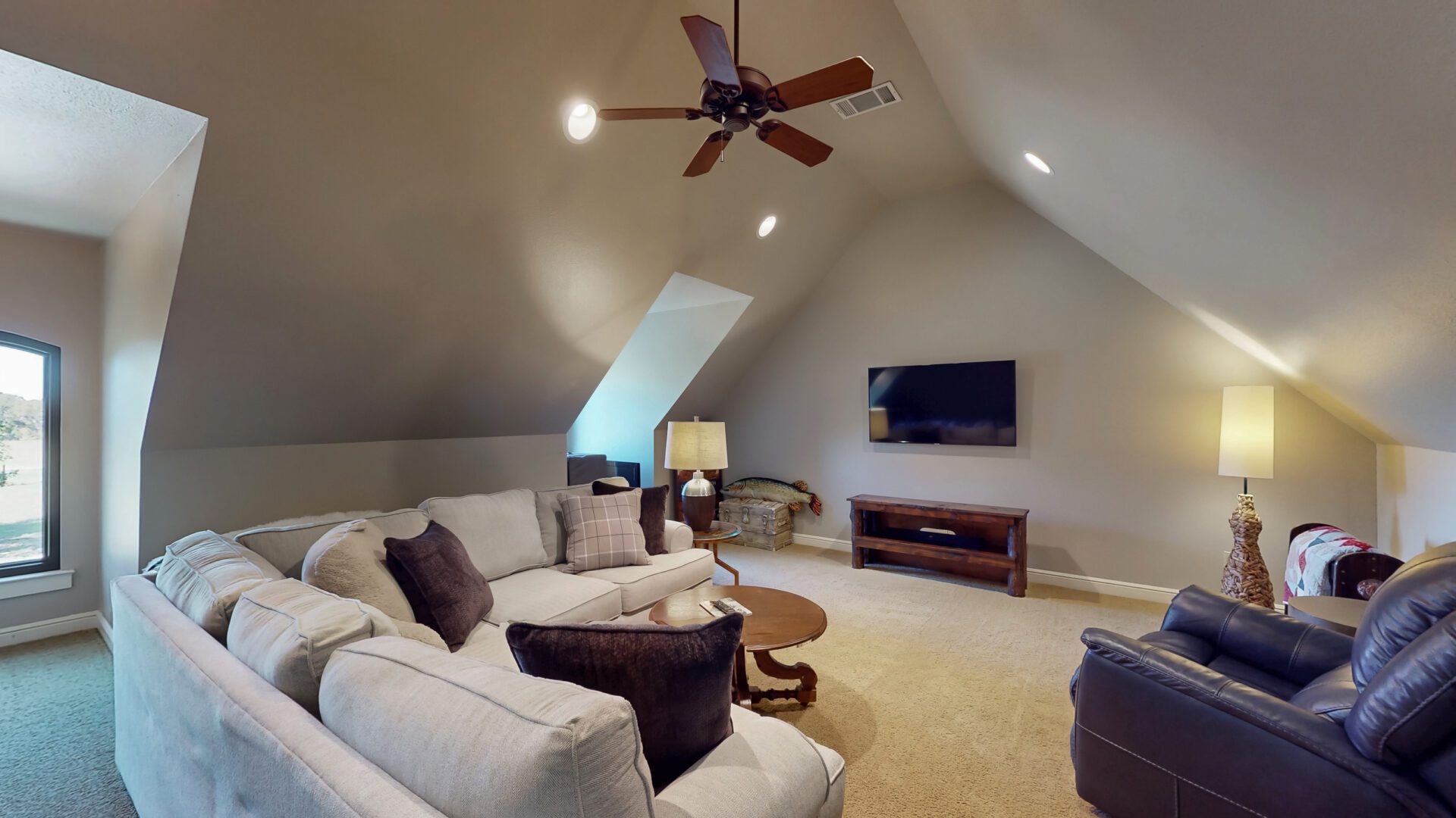 Spacious attic living room with TV