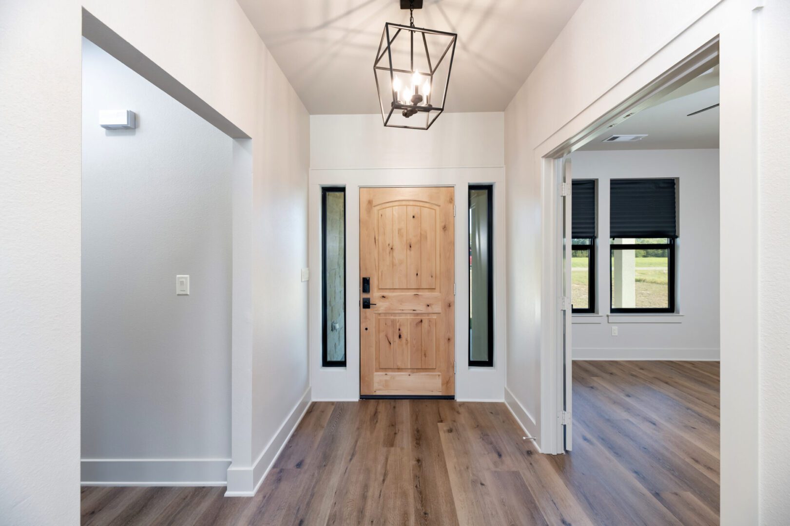Wooden front door with sidelights