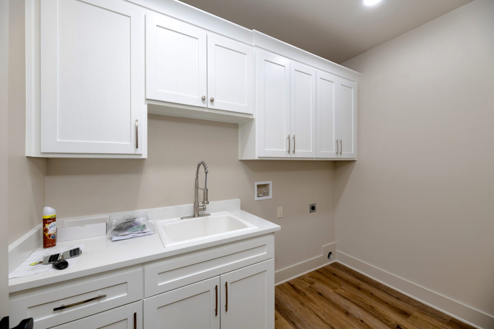 Modern laundry room with wood flooring
