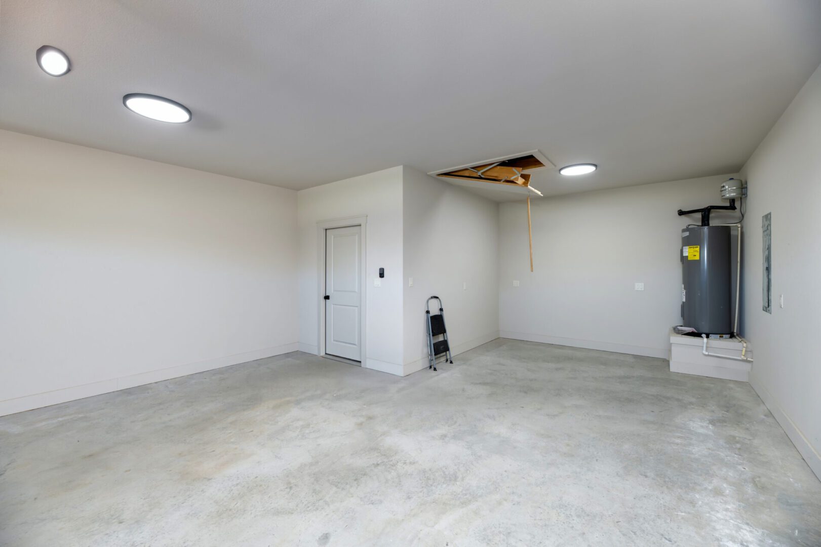 Empty garage with exposed ceiling panel