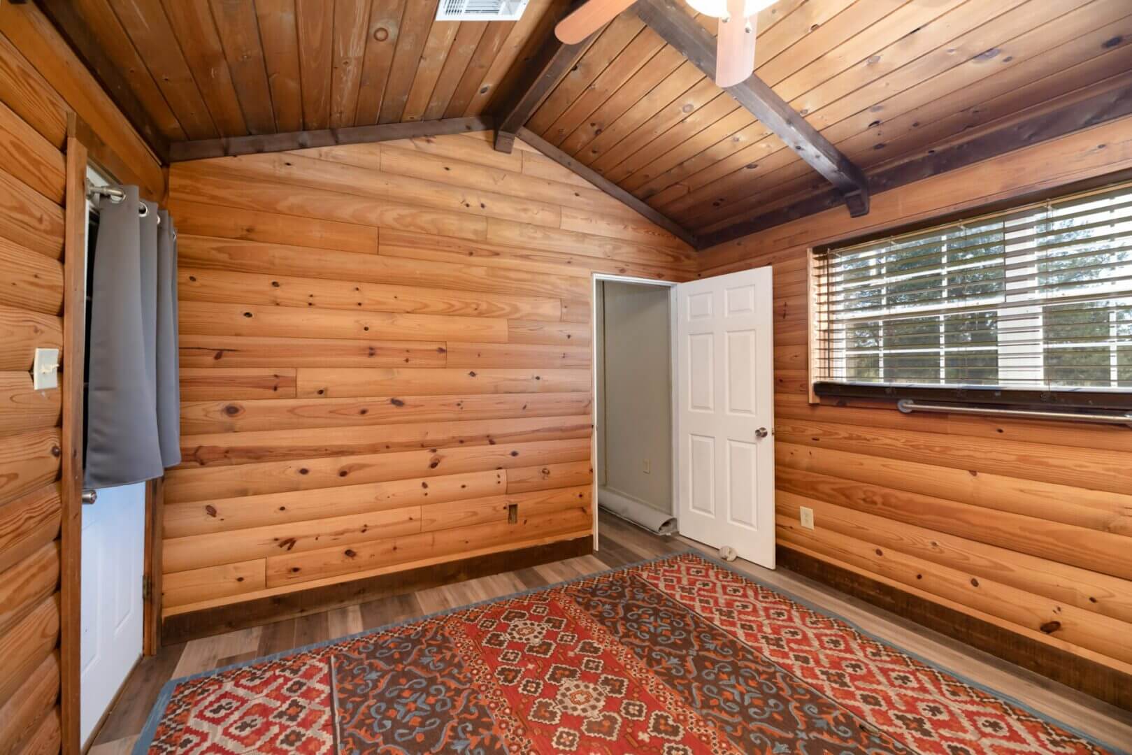 Wood-paneled room with colorful rug