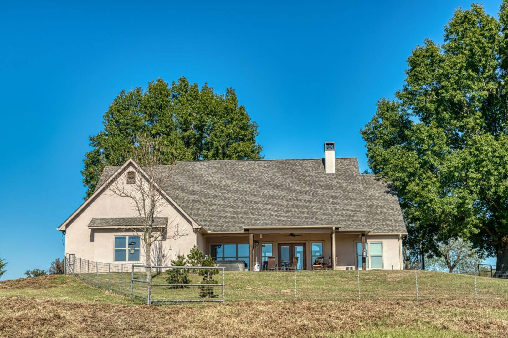 A charming house with a wooden porch under a clear blue sky.