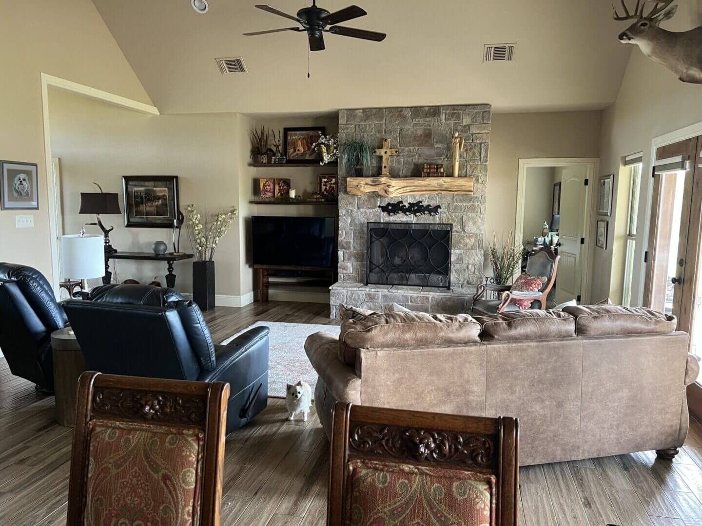 Cozy living room with stone fireplace and comfortable seating.